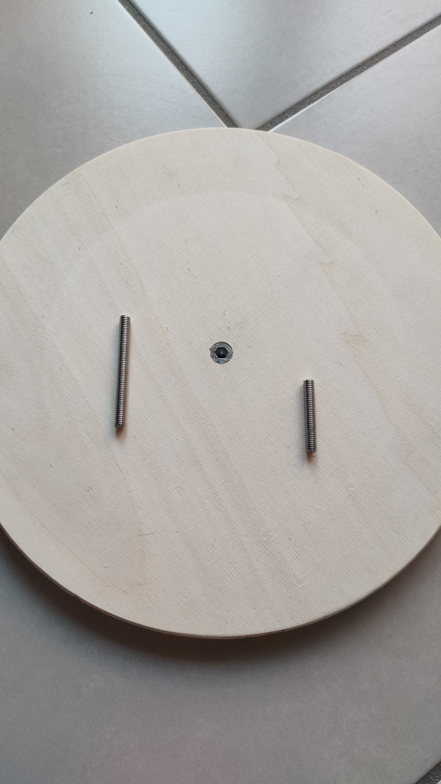 View of the pins that rotate the wooden discs. The pins are made of metal and are hand-screwed