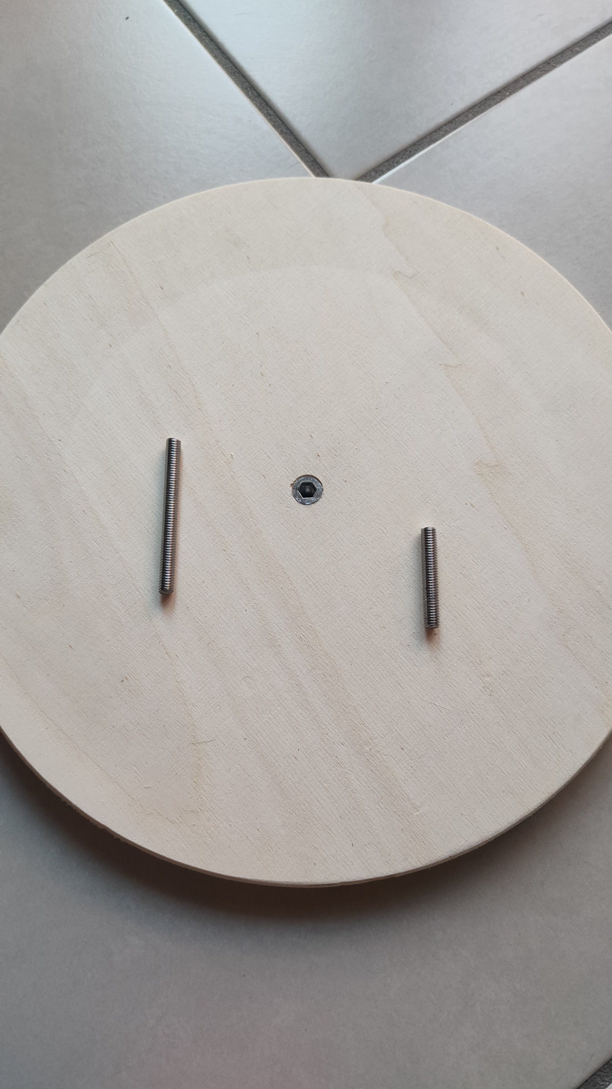 View of the pins that rotate the wooden discs. The pins are made of metal and are hand-screwed